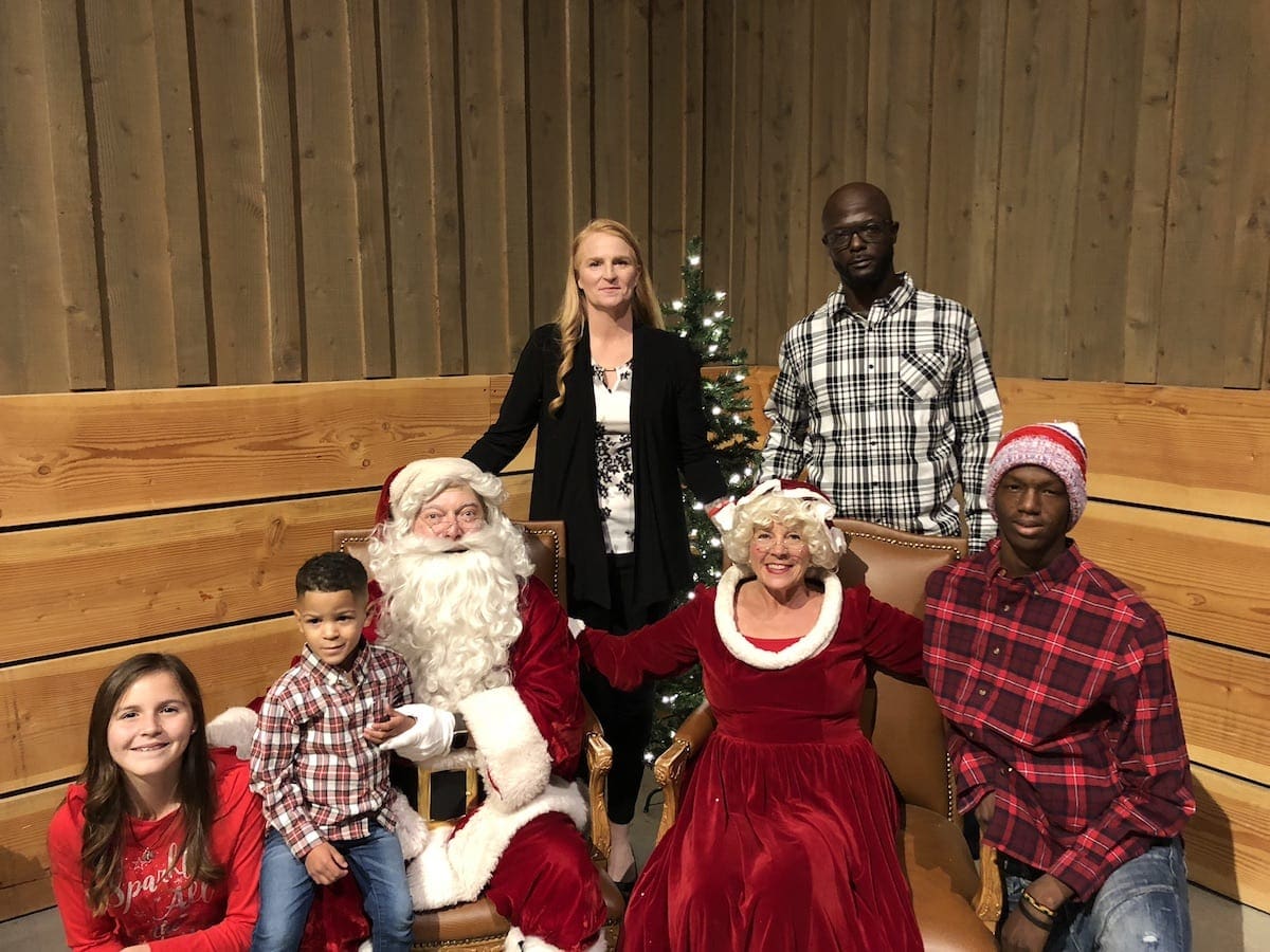 A military family poses with Mr. and Mrs. Claus
